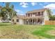 Charming two-story home with a welcoming front porch and red shutters at 2512 Rustic Oaks Dr, Lutz, FL 33559