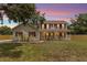 Charming two-story home featuring a spacious front porch and well-maintained lawn at 2512 Rustic Oaks Dr, Lutz, FL 33559