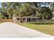 Well-maintained two-story home with long driveway, large front yard and beautiful mature trees at 2512 Rustic Oaks Dr, Lutz, FL 33559