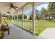 Inviting front porch with ceiling fans, seating, and lovely views at 2512 Rustic Oaks Dr, Lutz, FL 33559