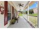 Inviting front porch with ceiling fans, seating, and lovely views at 2512 Rustic Oaks Dr, Lutz, FL 33559