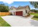 View of the home showcasing the garage and driveway at 2512 Rustic Oaks Dr, Lutz, FL 33559