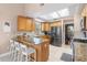 Bright kitchen with stainless steel appliances, granite countertops, and a breakfast bar at 2512 Rustic Oaks Dr, Lutz, FL 33559