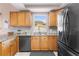 Spacious kitchen featuring stainless steel appliances, wood cabinets, and granite countertops at 2512 Rustic Oaks Dr, Lutz, FL 33559