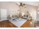 Spacious living room with high ceilings, hardwood floors, and a ceiling fan at 2512 Rustic Oaks Dr, Lutz, FL 33559