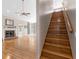 Bright open floor plan with staircase and gleaming hardwood floors, fireplace, and high ceiling at 2512 Rustic Oaks Dr, Lutz, FL 33559