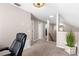 Bright loft area with beige walls, neutral carpet, and a view of the staircase at 2512 Rustic Oaks Dr, Lutz, FL 33559