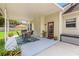 Spacious covered patio with an outdoor dining set and a well-maintained backyard at 2512 Rustic Oaks Dr, Lutz, FL 33559