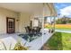 Relaxing covered patio with table set, plants and view of the pool at 2512 Rustic Oaks Dr, Lutz, FL 33559