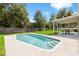 Backyard featuring a well-kept pool, patio, and lush lawn at 2512 Rustic Oaks Dr, Lutz, FL 33559