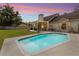 Sparkling pool with covered patio, seating, and lush backyard perfect for outdoor enjoyment at 2512 Rustic Oaks Dr, Lutz, FL 33559