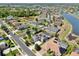 Aerial view of a residential neighborhood featuring mature trees, ponds, and well-maintained homes at 2517 Cumberland Cliff Dr, Ruskin, FL 33570