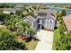 Aerial view of beautiful home with solar panels, well-manicured lawn, and spacious driveway at 2517 Cumberland Cliff Dr, Ruskin, FL 33570