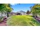 Expansive backyard with lush green grass and screened-in lanai with ample space for entertaining at 2517 Cumberland Cliff Dr, Ruskin, FL 33570