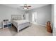 Bedroom features tile floors, neutral paint, and a queen bed with stylish decor at 2517 Cumberland Cliff Dr, Ruskin, FL 33570