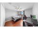 Bedroom with laminate floors, closet, desk, and a window providing natural light and views at 2517 Cumberland Cliff Dr, Ruskin, FL 33570