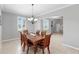 Formal dining room with wooden table and chairs, chandelier lighting, and views to living area at 2517 Cumberland Cliff Dr, Ruskin, FL 33570