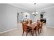 Formal dining room with wooden table and chairs, chandelier lighting, and views to living area at 2517 Cumberland Cliff Dr, Ruskin, FL 33570