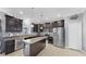 Open-concept kitchen with stainless steel appliances, granite countertops, and center island at 2517 Cumberland Cliff Dr, Ruskin, FL 33570