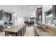 Modern kitchen features tile floors, granite countertops, stainless steel sink, and dark wood cabinets at 2517 Cumberland Cliff Dr, Ruskin, FL 33570