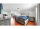 Spacious main bedroom features a luxurious bed, wood floors, an ensuite desk, and a sizable closet at 2517 Cumberland Cliff Dr, Ruskin, FL 33570