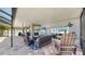 Spacious covered patio featuring an outdoor kitchen, dining area, and living area at 2517 Cumberland Cliff Dr, Ruskin, FL 33570