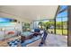 Screened-in patio featuring comfortable seating area with fire pit, TV, and tiled flooring at 2517 Cumberland Cliff Dr, Ruskin, FL 33570