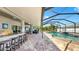 Relaxing outdoor area includes bar seating, a dining area and a screened in pool at 2517 Cumberland Cliff Dr, Ruskin, FL 33570