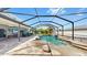 Wide view of a screened-in pool, patio, dining area, and outdoor kitchen at 2517 Cumberland Cliff Dr, Ruskin, FL 33570