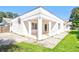 Backyard featuring a covered porch, lush green grass, and privacy fence at 2675 Firestone Dr, Clearwater, FL 33761