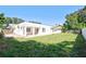 Expansive backyard with lush green grass and white privacy fence, perfect for outdoor activities at 2675 Firestone Dr, Clearwater, FL 33761