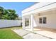 View of backyard with privacy fence and a covered patio featuring white columns and a ceiling fan at 2675 Firestone Dr, Clearwater, FL 33761