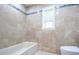 Elegant bathroom with tile walls and a stylish bathtub at 2675 Firestone Dr, Clearwater, FL 33761