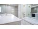Bright bathroom featuring a double sink vanity, a soaking tub, and a walk-in shower at 2675 Firestone Dr, Clearwater, FL 33761