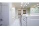 Bright bathroom with double sinks, a soaking tub, walk in shower and tile floors at 2675 Firestone Dr, Clearwater, FL 33761