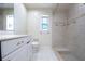 Bathroom featuring walk-in shower, built in bench and grab bars at 2675 Firestone Dr, Clearwater, FL 33761