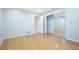 Bedroom with hardwood floors, closet with sliding mirror doors and neutral color palette at 2675 Firestone Dr, Clearwater, FL 33761
