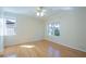 Bright bedroom featuring hardwood floors, a ceiling fan and two windows with outdoor views at 2675 Firestone Dr, Clearwater, FL 33761