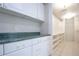 Walk-in closet with custom cabinets, shelving and granite countertop at 2675 Firestone Dr, Clearwater, FL 33761