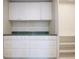 Walk-in closet with custom cabinets, shelving and granite countertop at 2675 Firestone Dr, Clearwater, FL 33761