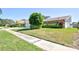 A charming single-story home with a well-maintained lawn, showcasing a classic brick exterior at 2675 Firestone Dr, Clearwater, FL 33761