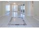 Bright foyer with tile flooring, transom windows, and a decorative marble design at 2675 Firestone Dr, Clearwater, FL 33761