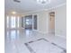 Spacious foyer featuring tile flooring, transom windows, and a modern chandelier at 2675 Firestone Dr, Clearwater, FL 33761