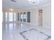 Bright foyer featuring tile flooring, neutral walls, and decorative glass doors at 2675 Firestone Dr, Clearwater, FL 33761