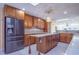Bright kitchen boasts wood cabinets, stainless steel refrigerator, marble counter tops and center island at 2675 Firestone Dr, Clearwater, FL 33761
