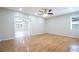 Spacious living room with hardwood floors, ceiling fan, and access to another room at 2675 Firestone Dr, Clearwater, FL 33761