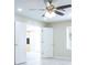 Living room with ceiling fan, tile floors and open doorways at 2675 Firestone Dr, Clearwater, FL 33761