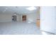 Spacious area featuring tile floors, recessed lighting, and views into the kitchen at 2675 Firestone Dr, Clearwater, FL 33761