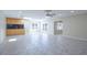 Open floor plan boasts tile floors, recessed lighting, wet bar, and sliding glass doors to the backyard at 2675 Firestone Dr, Clearwater, FL 33761