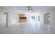Open floor plan boasts tile floors, recessed lighting, wet bar, and sliding glass doors to the backyard at 2675 Firestone Dr, Clearwater, FL 33761
